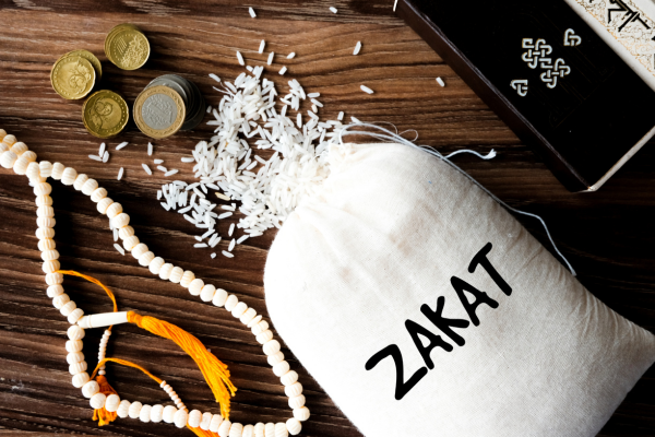 Bag of rice, tasbih beads and coins depicting zakat