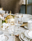 Lilac drinkware with golden and white design  placed on dining table